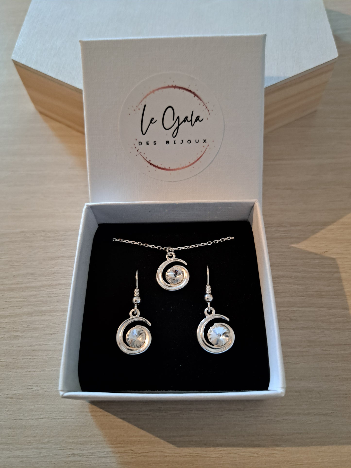 Boucle d'oreilles argentées lune ornées d'un cristal blanc